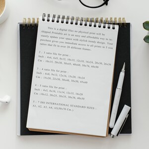 May include: A white sheet of paper with black ink handwritten text listing different print sizes in inches and centimeters. The text includes the ratios 2:3, 3:4, 4:5, and 5:7. The text also mentions ISO International Standard Sizes: A1, A2, A3, A4, and A5 (50x70 cm).