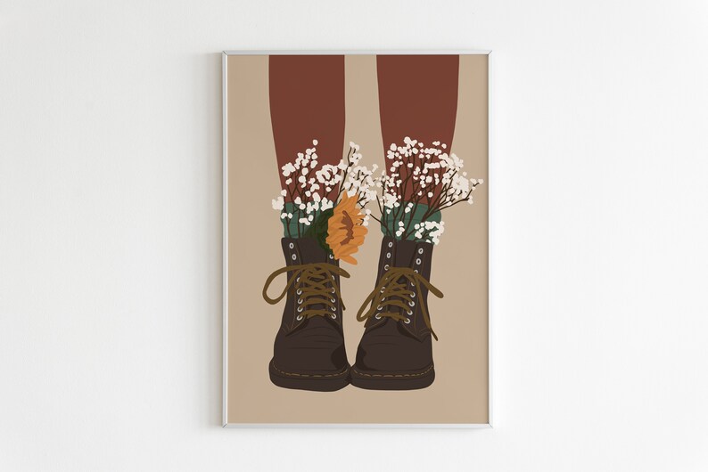 May include: A pair of brown leather boots with laces, each with a bouquet of white flowers and a single orange flower tucked inside.