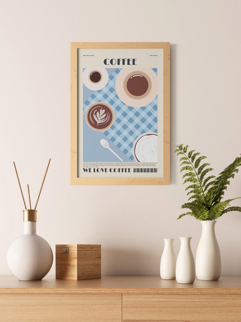 May include: A framed print featuring coffee cups and the word "COFFEE" in a minimalist design. The print includes the text "WE LOVE COFFEE" at the bottom. The background is a light blue checkered pattern.