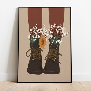 May include: A pair of brown leather boots with white and green flowers growing out of them. The boots have laces and are tied at the top. The background is a light brown color.