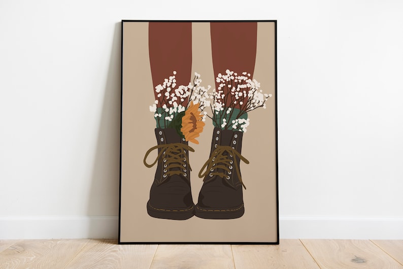 May include: A pair of brown leather boots with white and green flowers growing out of them. The boots have laces and are tied at the top. The background is a light brown color.