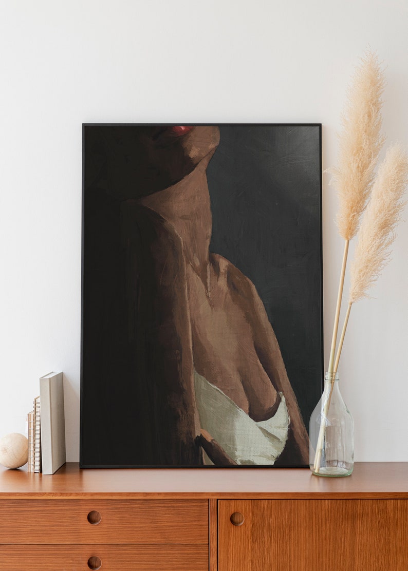 May include: A framed painting of a person's torso with a dark background. The person is wearing a white top and has a red lip.