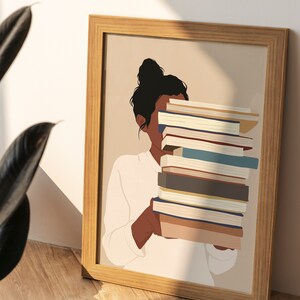Peut inclure: Illustration encadr&eacute;e d'une personne tenant une pile de livres. Le visage est partiellement cach&eacute;. Les livres ont des dos de couleurs vari&eacute;es, et le cadre est en bois clair. Th&egrave;me litt&eacute;raire.