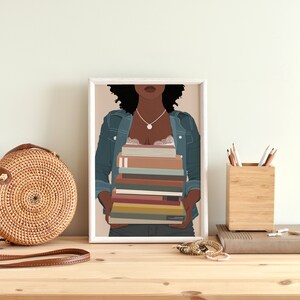 May include: A framed illustration of a Black woman wearing a denim jacket and holding a stack of colorful books. The background is a light peach color.
