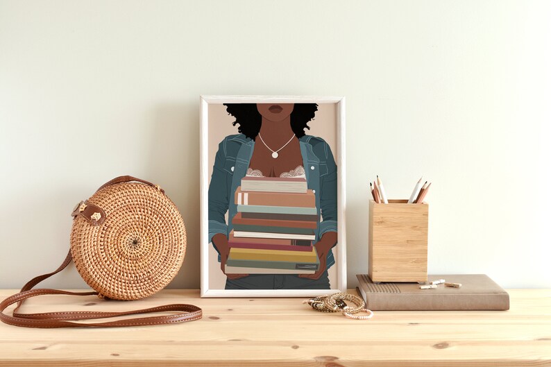 May include: A framed illustration of a Black woman wearing a denim jacket and holding a stack of colorful books. The background is a light peach color.