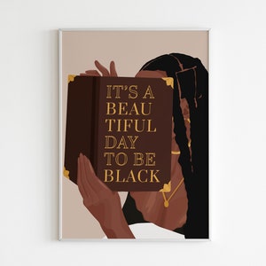 May include: A woman with long black hair holds a book in front of her face. The book is brown with gold lettering that reads "It's a beautiful day to be black."