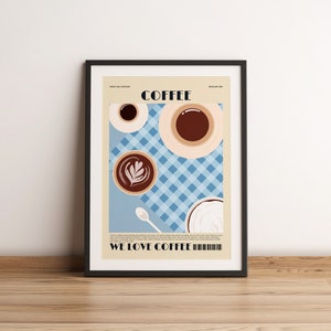 May include: Framed art print featuring a coffee-themed illustration. The artwork includes coffee cups, a spoon, and the text "COFFEE" and "WE LOVE COFFEE". The background has a blue and white checkered pattern.