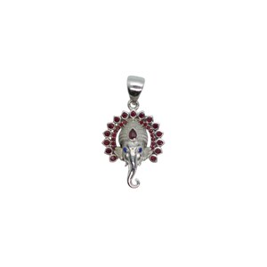 May include: A silver pendant featuring the Hindu deity Ganesha. The pendant has a detailed elephant head with blue eyes and a red gem on the forehead. A halo of red gems surrounds the head.