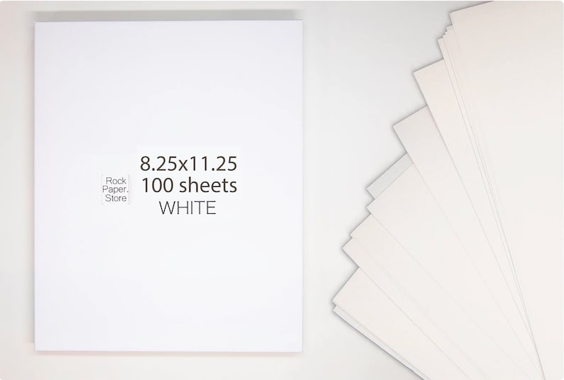 May include: A pack of 100 white sheets of paper, measuring 8.25x11.25 inches. The paper is stacked and fanned out, showing the white colour.