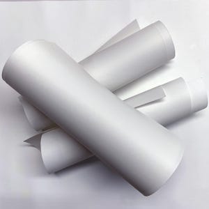 May include: Rolls of white vinyl adhesive paper, ideal for crafting and DIY projects.