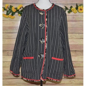 May include: Black and white striped jacket with red trim and floral button accents.