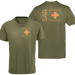 May include: A green t-shirt with the words "SEARCH RESCUE" and a red cross on the front. The back of the shirt has the words "SAR SEARCH RESCUE" and a red cross.