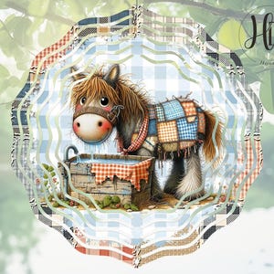 以下が含まれることがあります： 青いバケツから水を飲む漫画の馬が描かれた、カラフルなパッチワークキルトデザインの風車。馬は茶色で顔は白く、背中には青と白のパッチワークキルトのデザインが施されています。風車は青と白の市松模様の背景になっています。