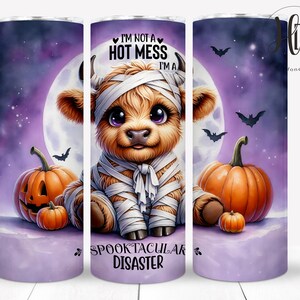 May include: A purple and white tumbler with a cartoon image of a mummy cow with a full moon in the background. The cow is wearing a white bandage and has the text "I'm not a hot mess I'm a spooktacular disaster" on the tumbler.