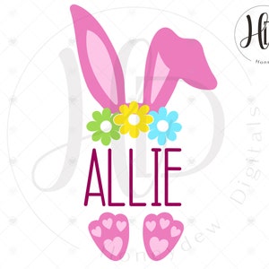 May include: A digital graphic featuring pink bunny ears, a floral crown with green, yellow, and blue flowers, the name "ALLIE" in a deep pink font, and pink paw prints. The design is on a white background.