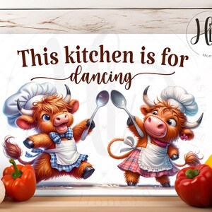 May include: A rectangular kitchen sign with the text "This kitchen is for dancing." Two cartoon cows wearing chef hats and aprons are holding spoons. The cows are brown with pink noses and are dancing.