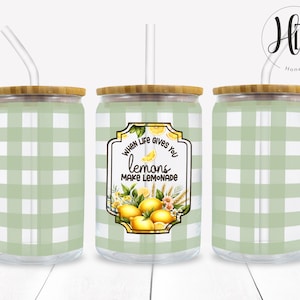 May include: Three green and white gingham patterned tumblers with bamboo lids and clear straws. The center tumbler has a yellow label with the text "When life gives you lemons make lemonade".