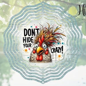 May include: A colorful metal wind spinner with a white background featuring a cartoon rooster with the text "Don't Hide Your Crazy!"