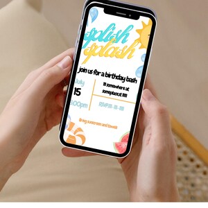 May include: A mobile phone screen shows a birthday party invitation with the words "splash splash" in blue and yellow. The invitation includes the date, time, and location, and asks guests to bring sunscreen and towels. The phone is held by a person.