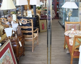 May include: A gold floor lamp with a geometric design and a square base. The lamp is in a room with furniture and other lamps.