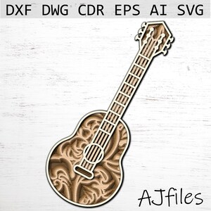 Peut inclure: Une guitare acoustique découpée au laser avec des motifs floraux complexes. La guitare est en bois et a une couleur brun clair.