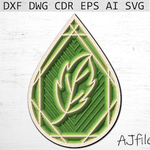 May include: A green and white layered papercraft design of a leaf inside a teardrop shape.