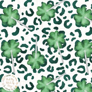 May include: A seamless pattern featuring green four-leaf clover lollipops on a white background with a teal leopard print.