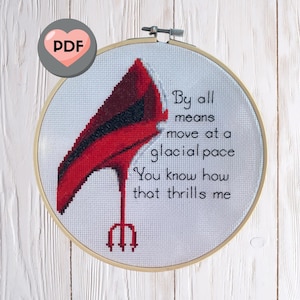 May include: Cross-stitch embroidery hoop with a red high heel shoe and a trident. The text reads "By all means move at a glacial pace You know how that thrills me."