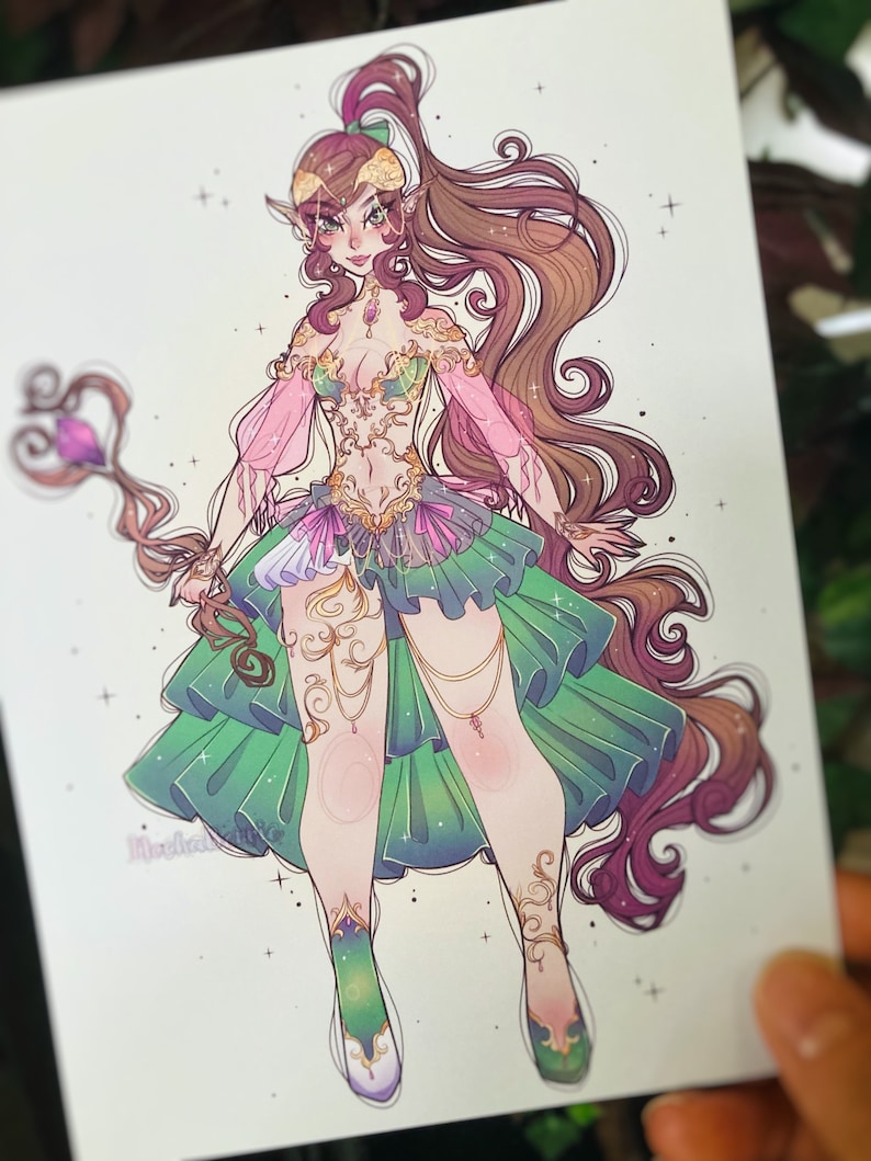 May include: A digital illustration of a character with long brown hair, pointed ears, and a staff topped with a purple crystal. The character wears a green and pink ruffled skirt, a gold-detailed bodice, and matching gold leg ornaments.