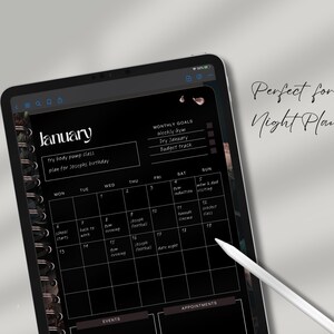 May include: A digital planner on a black tablet displays a January calendar with a spiral binding. The screen shows a monthly view with daily entries and a section for monthly goals. A white stylus points to the calendar. Text on the screen includes "try body pump class" and "plan for Joseph's birthday."