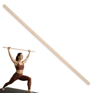 May include: A long, light-coloured wooden dowel, suitable for exercise and stretching. The dowel is held overhead by a person in athletic wear, demonstrating a workout. The dowel is approximately 152 cm long.