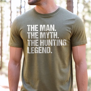 May include: A green t-shirt with white text that reads "The Man. The Myth. The Hunting Legend."