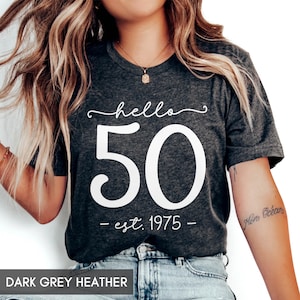 May include: Dark grey heather t-shirt with white text that reads "hello 50 - est. 1975 - "
