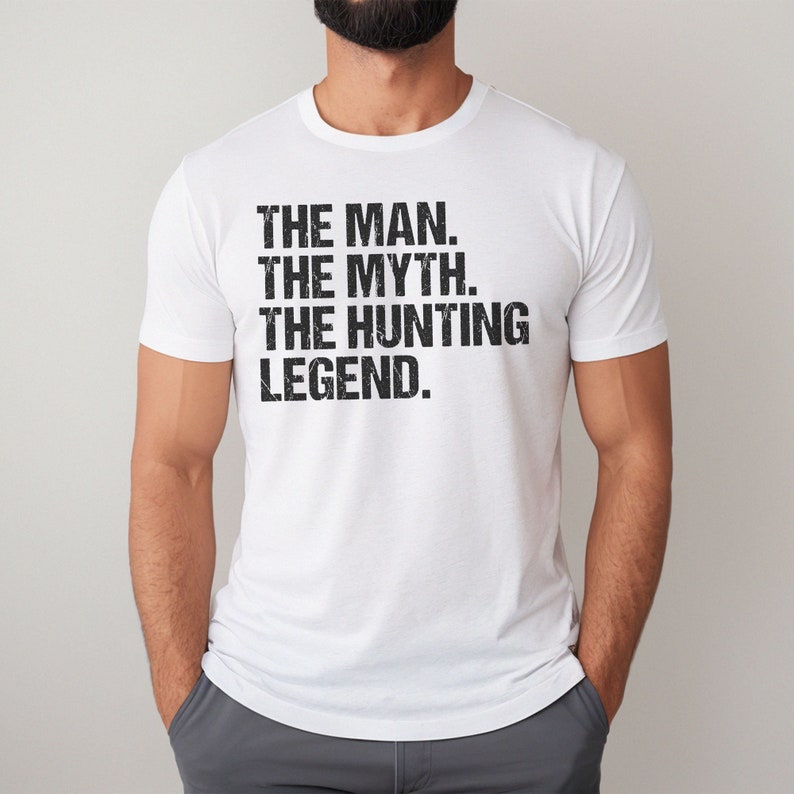 May include: White t-shirt with black text that reads "THE MAN. THE MYTH. THE HUNTING LEGEND."