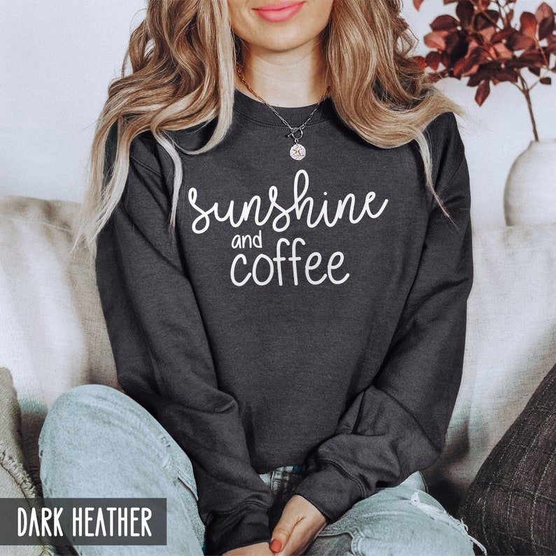 May include: A dark heather grey sweatshirt with the text "sunshine and coffee" in white lettering.
