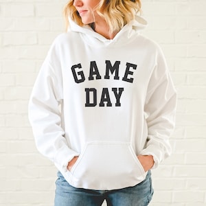 May include: White hooded sweatshirt with black text that reads "GAME DAY".