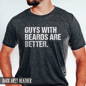 May include: A dark grey heather t-shirt with the text "Guys with beards are better." printed in white.