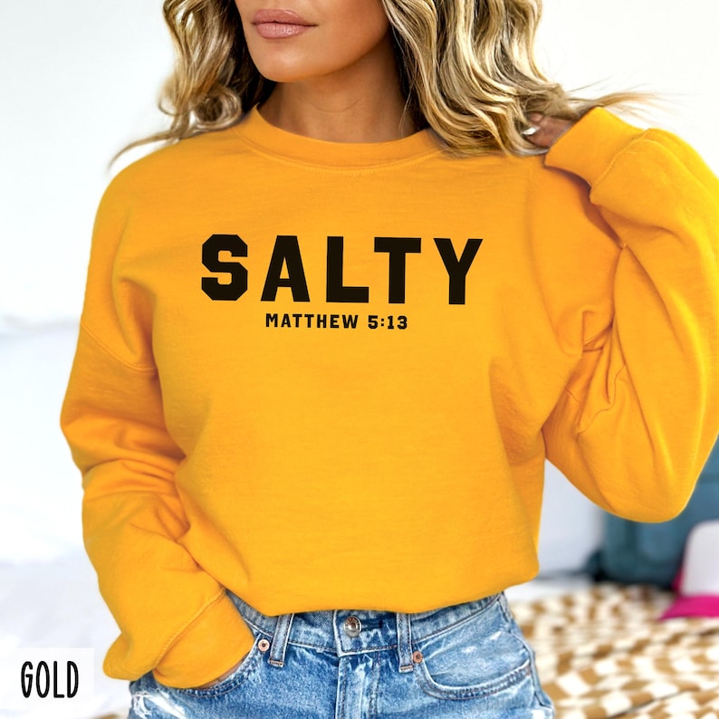 May include: A yellow sweatshirt with black text that reads "SALTY" and "MATTHEW 5:13".