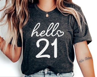 May include: A dark grey heather t-shirt with the text "hello 21" in white lettering with a small heart symbol.