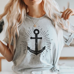 May include: A grey t-shirt with a black anchor graphic and the text "Rhode Island".