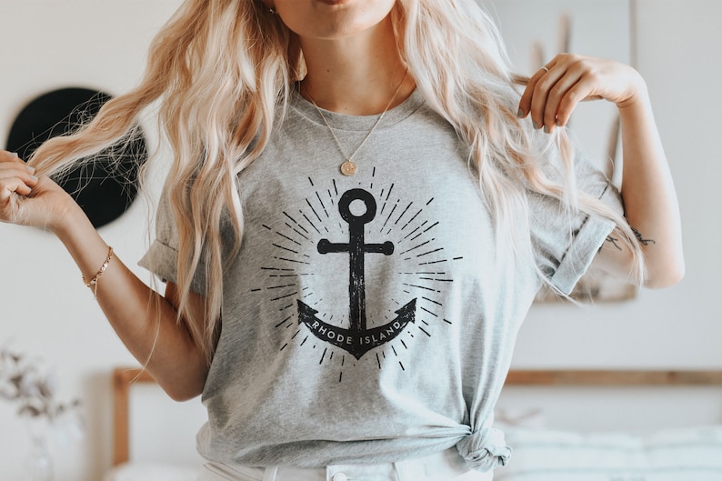 May include: A grey t-shirt with a black anchor graphic and the text "Rhode Island".