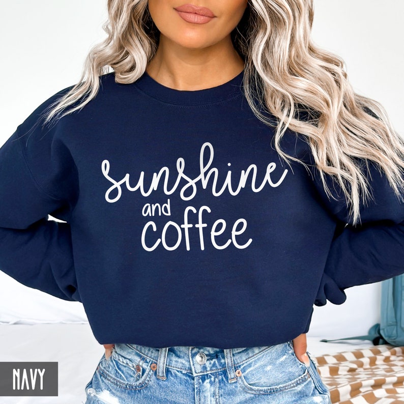May include: A navy blue sweatshirt with the text "sunshine and coffee" in white lettering.
