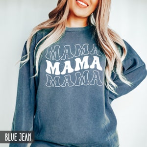 May include: A blue jean sweatshirt with the text "MAMA" repeated three times in a retro font.