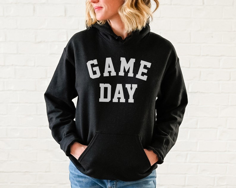 May include: Black hooded sweatshirt with the text "GAME DAY" in white letters.