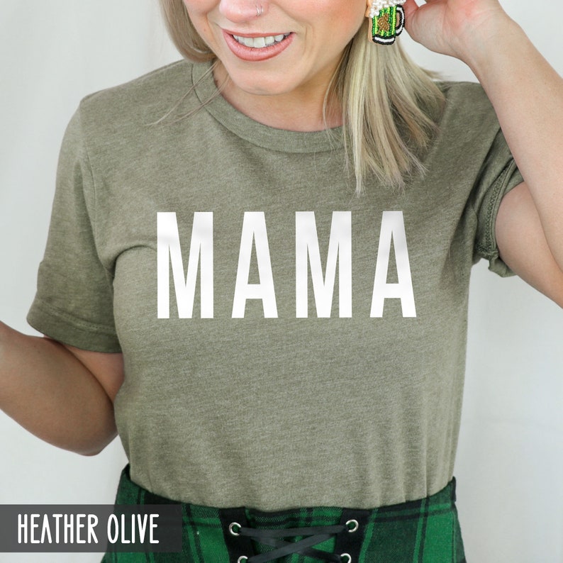 May include: A heather olive t-shirt with the word "MAMA" printed in white on the front.