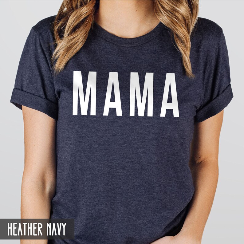 May include: A heather navy blue t-shirt with the word "MAMA" printed in white on the front.