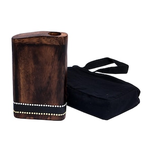 May include: A rectangular, dark brown wooden box with a rounded top and a small hole. The box has a black band with white and gold dots. A black fabric bag with a black strap is next to the box.