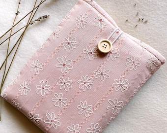 May include: A pink fabric pouch with a white floral pattern and a light brown button closure. The pouch is on a white background with dried lavender sprigs.