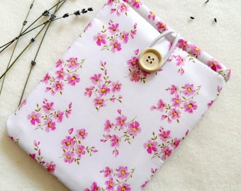 May include: A white fabric pouch with a pink floral pattern and a wooden button closure.