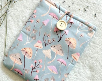 May include: A light blue fabric case with a mushroom pattern. The case has a button closure and a loop for a strap.